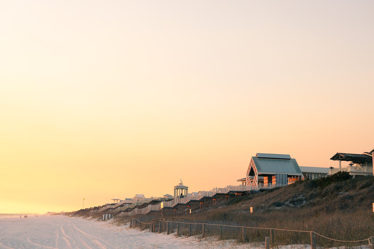 Crafting Captivating Headlines: Your awesome post title goes here Golden sunrise over Destin Beach with charming seaside cottages and serene sands.